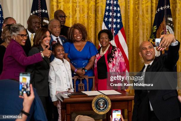 Sen. Cory Booker , right, take a selfie with Vice President Kamala Harris, Gianna Floyd, daughter of George Floyd, and others after President Joe...