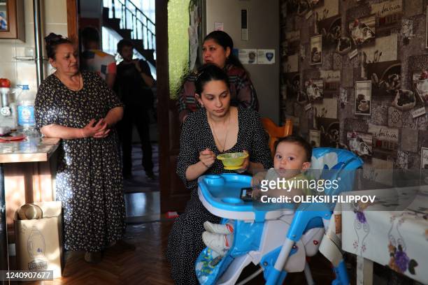 The Roma minority family of 59-year-old Lyudmyla stand in her house in Trebukhiv village, Kyiv region on May 25, 2022. Like her, many Ukrainian Roma...