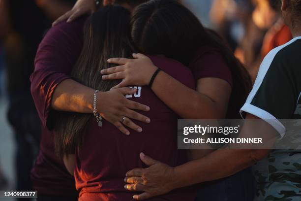 People mourn as they attend a vigil for the victims of the mass shooting at Robb Elementary School in Uvalde, Texas on May 25, 2022. - The tight-knit...