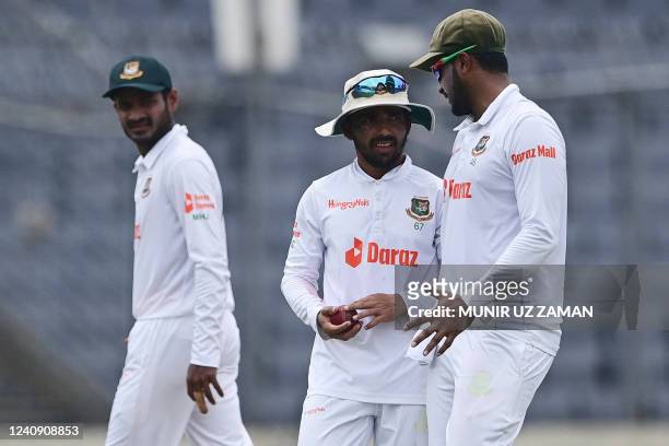 Bangladesh's Shakib Al Hasan and Bangladesh's captain Mominul Haque talk during the fourth day of the second Test cricket match between Bangladesh...
