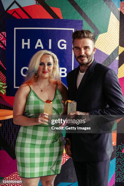 In this handout by Haig, Aimee Phillips and David Beckham sip on the drink of the summer, Haig Club Mediterranean Orange, launching a series of...