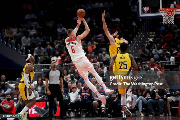 Washington Wizards center Kristaps Porzingis shoots for two over Indiana Pacers center Goga Bitadze in the fourth quarter at Capital One Arena March...