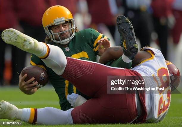 Green Bay Packers quarterback Aaron Rodgers , left, is sacked by Washington Football Team defensive lineman Jonathan Allen in the 1st quarter during...