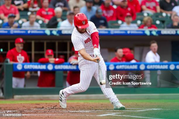 Tommy White of the NC State Wolfpack makes contact with the ball while at bat during the ACC Baseball Championship Tournament between the Miami...