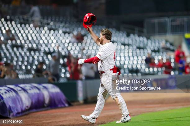 Tommy White of the NC State Wolfpack tips his helmet to the crowd after receiving a standing ovation during the ACC Baseball Championship Tournament...
