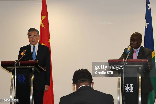 Chinese Foreign Minister Wang Yi and his counterpart Solomon Islands' Jeremiah Manele attend a press conference in Honiara on May 26, 2022. - China...