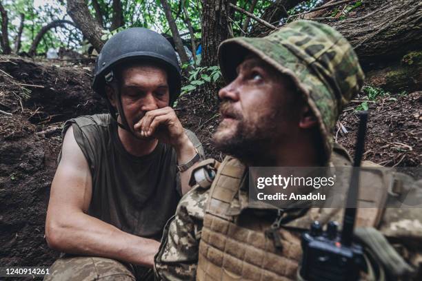 Ukrainian soldiers shelter from shelling on the Donbass frontline, Ukraine, 25 May 2022