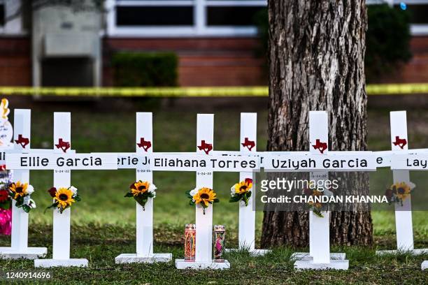 Crosses adorn a makeshift memorial for the shooting victims at Robb Elementary School in Uvalde, Texas, on May 26, 2022. - Grief at the massacre of...