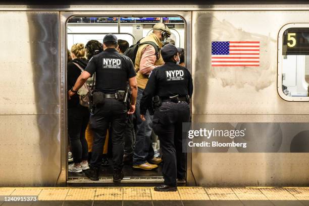 New York Police Department officers enter a subway at a station in New York, US, on Wednesday, May 25, 2022. New York City's subway system is...