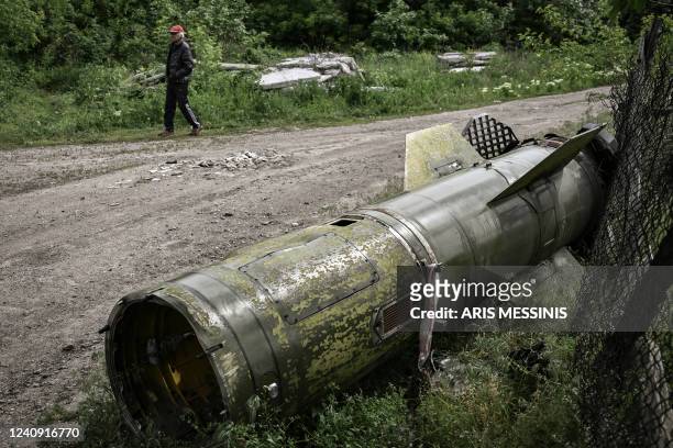 Man walks near the remains of a missile in the city of Lysychansk, in the eastern Ukrainian region of Donbas, on May 26, 2022. Ukraine said may 26...