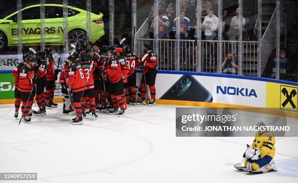 Canada's players celebrate the 3-4 goal as Sweden's goalkeeper Linus Ullmark reacts during the IIHF Ice Hockey World Championships quarterfinal match...