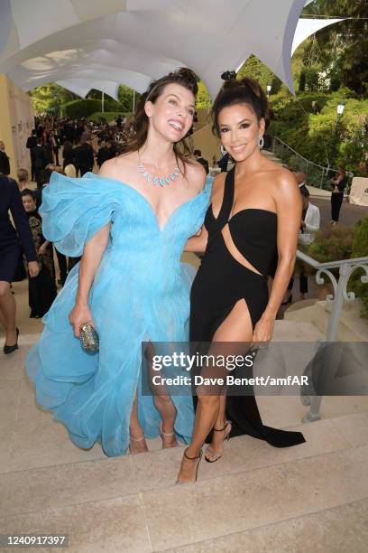 Milla Jovovich and Eva Longoria attend the amfAR Gala Cannes 2022 at the Hotel du Cap-Eden-Roc on May 26, 2022 in Cap d'Antibes, Côte d'Azur.