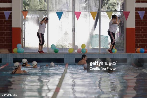 Two instructors in front of a group of inhabitants of Milpa Alta in Mexico City, during an exhibition of Aqua Zumba or zumba in a pool on the...