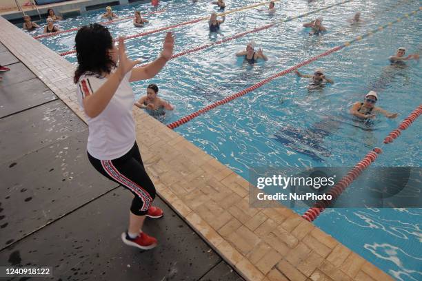 An instructor in front of a group of inhabitants of Milpa Alta in Mexico City, during an exhibition of Aqua Zumba or zumba in a pool on the occasion...