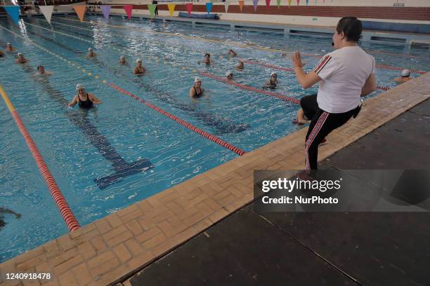 An instructor in front of a group of inhabitants of Milpa Alta in Mexico City, during an exhibition of Aqua Zumba or zumba in a pool on the occasion...