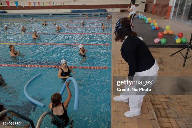 Group of inhabitants of Milpa Alta in Mexico City, Mexico, hold foami cylinders during an exhibition of Aqua Zumba or zumba in a swimming pool on the...