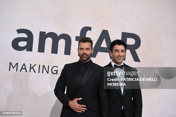 Puerto Rican singer actor Ricky Martin and Syrian-born Swedish painter Jwan Yosef arrive on May 26, 2022 to attend the annual amfAR Cinema Against...