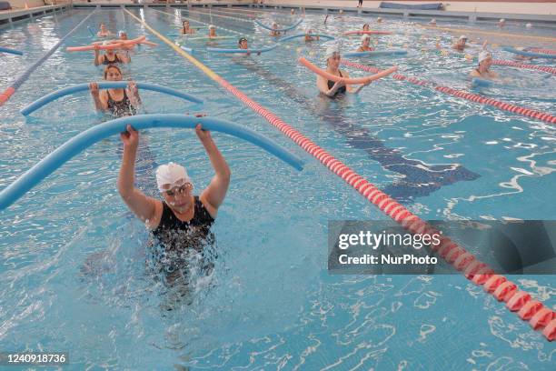 Group of inhabitants of Milpa Alta in Mexico City, Mexico, hold foami cylinders during an exhibition of Aqua Zumba or zumba in a swimming pool on the...