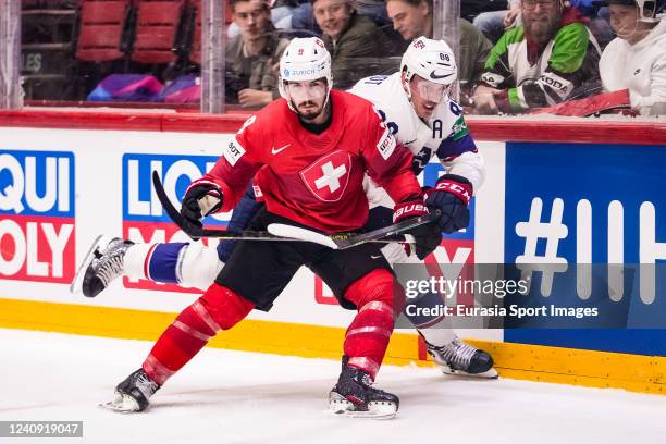 Damien Riat of Switzerland against Nate Schmidt of United States during the 2022 IIHF Ice Hockey World Championship match between Switzerland and USA...