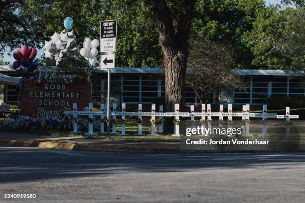 Crosses bearing the names of the victims of a mass shooting are seen in front of Robb Elementary School on May 26, 2022 in Uvalde, Texas. The rural...