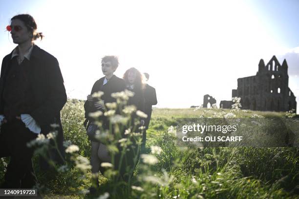 Vampires walk in the grounds of Whitby Abbey ahead of a Guinness world record attempt to gather the largest number of vampires together in one place,...