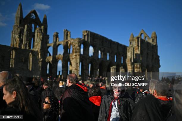 Vampires wait in the grounds of Whitby Abbey during a Guinness world record attempt to gather the largest number of vampires together in one place,...