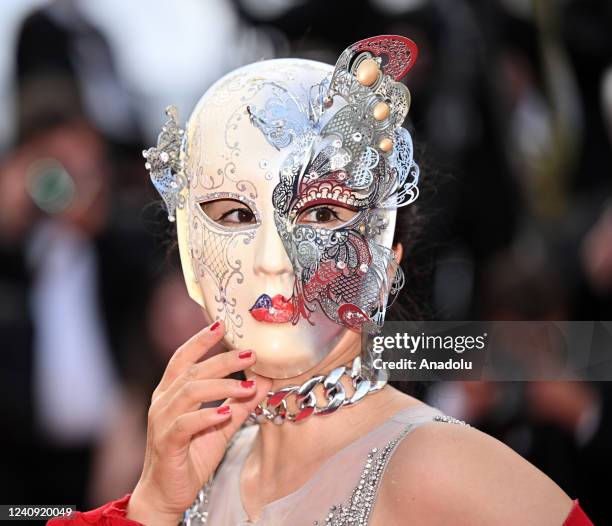 Masked guest arrives for the screening of the film Broker at the 75th annual Cannes Film Festival in Cannes, France on May 26, 2022.