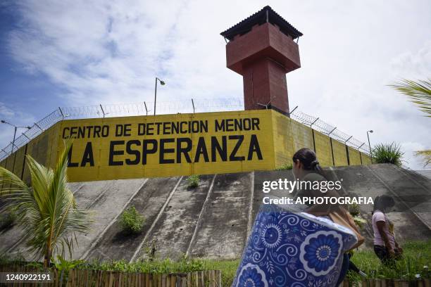 Salvadoran carries items for a jailed relative at the La Esperanza penitentiary center on May 26, 2022 in San Salvador, El Salvador. The Legislative...