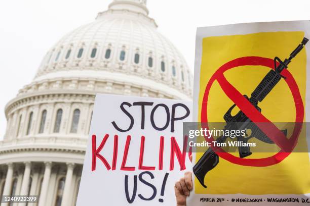 Demonstrators hold signs during a rally with senators outside the U.S. Capitol to demand the Senate take action on gun safety on Thursday, May 26 in...