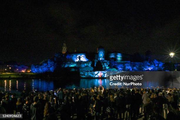 People watching the famous Wawel Castle illuminated during the Stranger Things 4 light show. Today, on the eve of the release of the fourth season of...