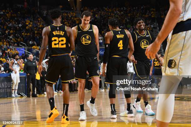 Andrew Wiggins hi-fives Nemanja Bjelica, Moses Moody and Kevon Looney of the Golden State Warriors during Game 5 of the 2022 NBA Playoffs Western...