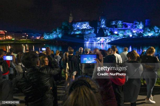 People watching the famous Wawel Castle illuminated during the Stranger Things 4 light show. Today, on the eve of the release of the fourth season of...