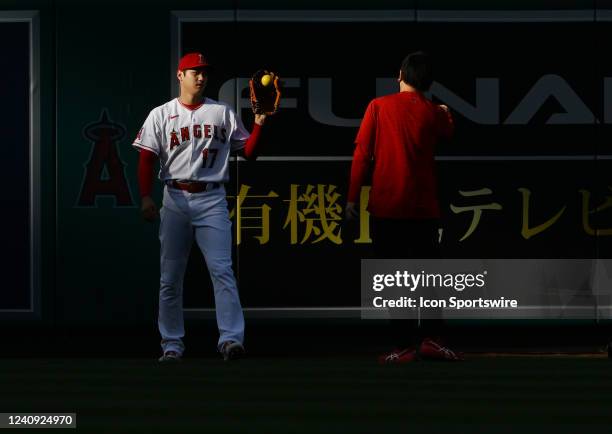 Los Angeles Angels pitcher Shohei Ohtani warming up in the outfield before the start of an MLB baseball game against the Toronto Blue Jays played on...