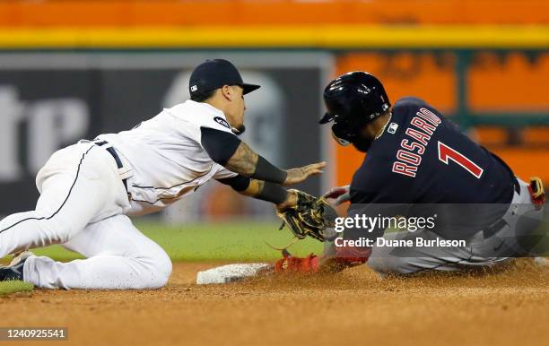 Shortstop Javier Baez of the Detroit Tigers tags out Amed Rosario of the Cleveland Guardians trying to stretch a hit into a double during the eighth...