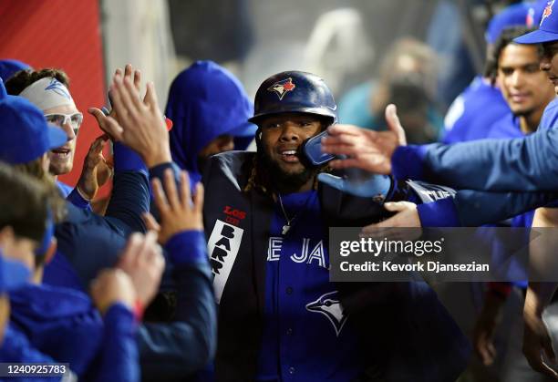 Vladimir Guerrero Jr. #27 of the Toronto Blue Jays celebrates after hitting a one run home run against starting pitcher Shohei Ohtani of the Los...