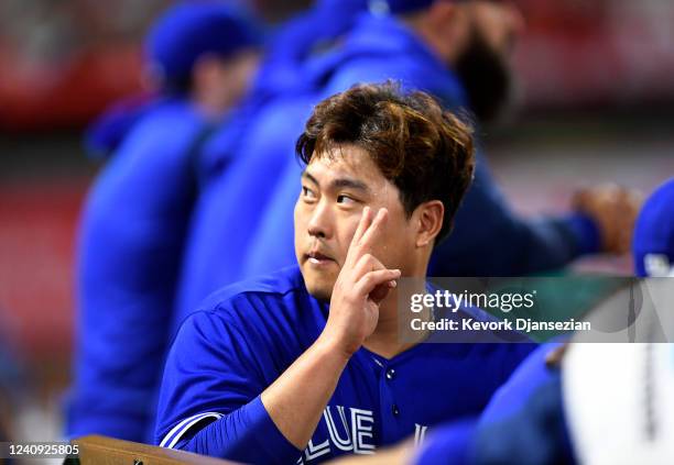 Starting pitcher Hyun Jin Ryu of the Toronto Blue Jays reacts to family members in the stands after the last out of the fifth inning and coming out...