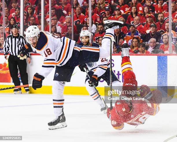Zach Hyman of the Edmonton Oilers crashes into Elias Lindholm of the Calgary Flames during the second period of Game Five of the Second Round of the...
