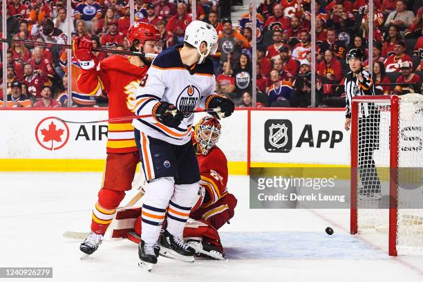 Jacob Markstrom of the Calgary Flames watches the shot of Connor McDavid of the Edmonton Oilers fly past him during the overtime period of Game Five...