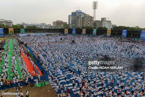 People participate in a mass yoga session at Lal Bahadur Shastri Stadium in Hyderabad on May 27, 2022.