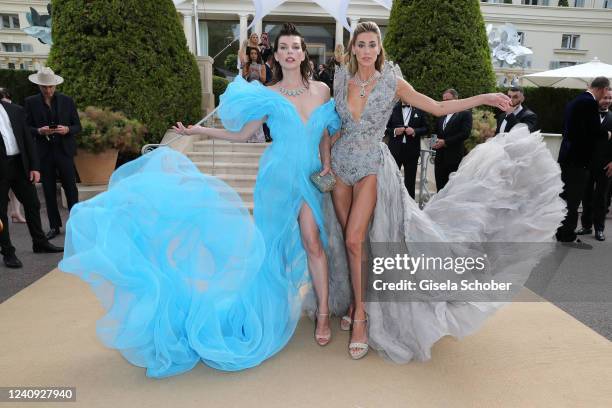 Milla Jovovich and Jessica Michel attend the amfAR Cannes Gala 2022 at Hotel du Cap-Eden-Roc on May 26, 2022 in Cap d'Antibes, France.