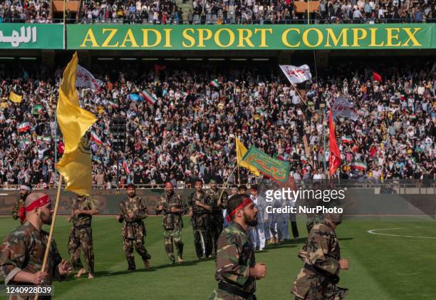 Members of the Iranian Basij paramilitary force carrying religious flags perform in a gathering to support of Irans Supreme Leader Ayatollah Ali...