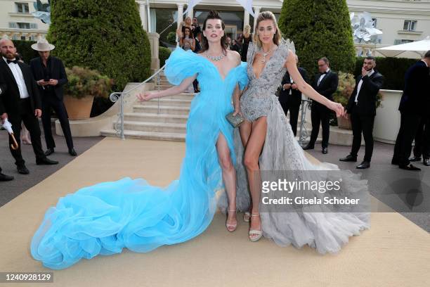 Milla Jovovich and Jessica Michel attend the amfAR Cannes Gala 2022 at Hotel du Cap-Eden-Roc on May 26, 2022 in Cap d'Antibes, France.