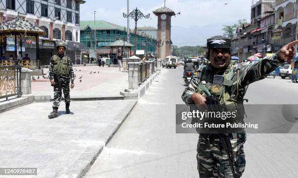 Indian paramilitary troopers stand guard along a road during a spontaneous strike in Srinagar on May 25 ahead of the sentencing hearing of...