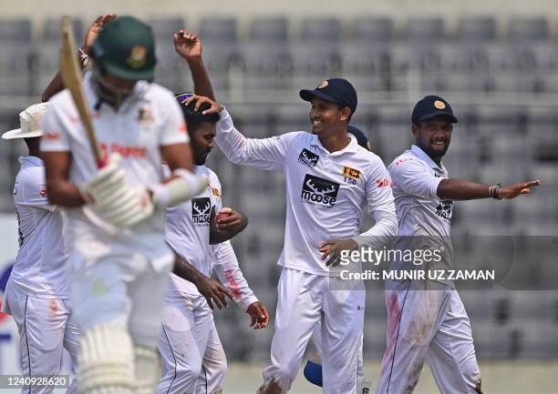 Sri Lankan players celebrate after the dismissal of Bangladesh's Khaled Ahmed during the final day of the second Test cricket match between...