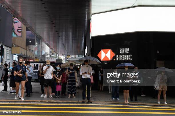 Pedestrians outside an HSBC Holdings Plc bank branch in the Central district in Hong Kong, China, on Tuesday, May 24, 2022. In Hong Kong, on Tuesday,...