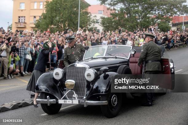 Spectators watch as an actor in his role as senior Nazi official Reinhard Heydrich performs during a re-enactment in Prague on May 27 during a...