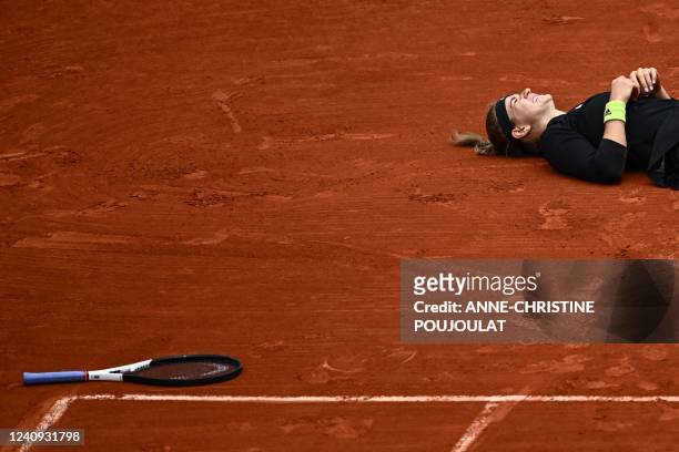 Czech Republic's Karolina Muchova reacts on the ground after an injury as she plays against US' Amanda Anisimova during their women's singles match...