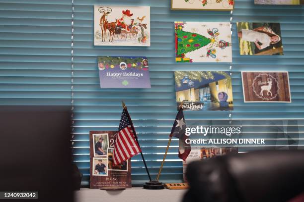 An American flag and Texas flag are seen in the office of Michael Derry, Superintendent of the Utopia School District on May 26, 2022 in Utopia,...
