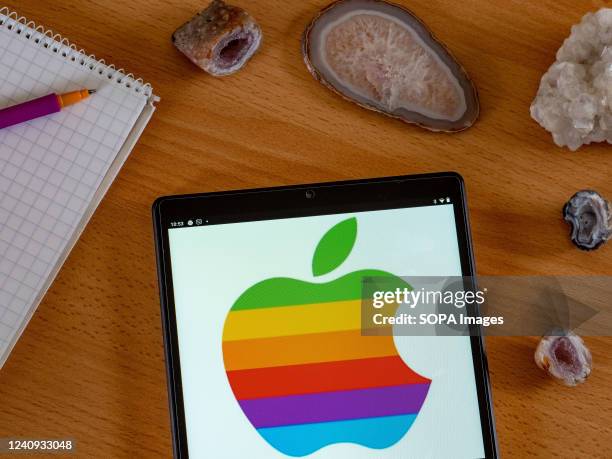 In this photo illustration, an Apple Inc. Logo seen displayed on a tablet screen.