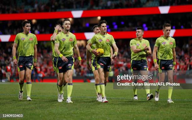 The umpires leave the field during the 2022 AFL Round 11 match between the Sydney Swans and the Richmond Tigers at the Sydney Cricket Ground on May...